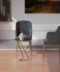 Angolo modern side table beside a minimalist chair and vase in a contemporary living space.