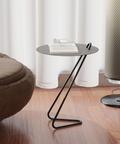 Angolo modern side table with a sleek design next to a cozy chair and a lamp, perfect for small spaces.