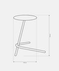 Modern metal side table with sculptural base beside bed for decor and essentials طاولة جانبية معدنية عصرية بتصميم نحتي موضوعة بجانب السرير للديكور والأغراض اليومية